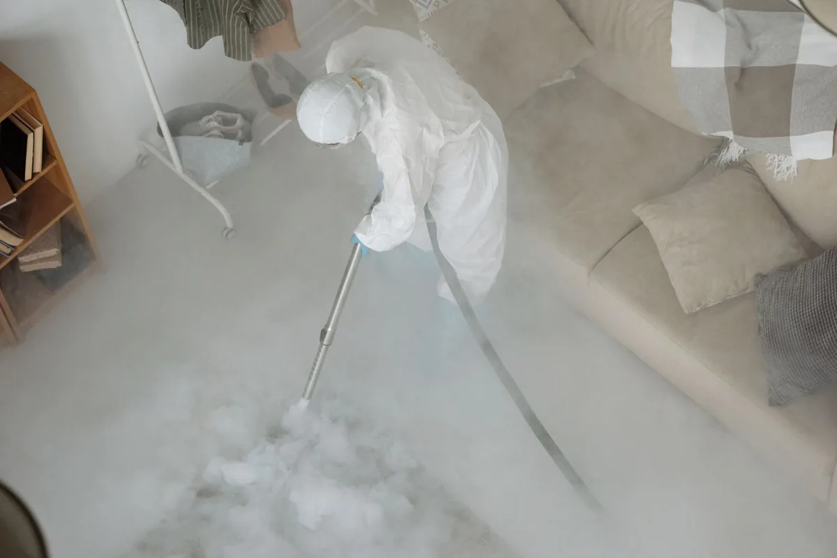 Biohazard cleanup technician in protective equipment, Polk Terrace, Dallas, TX